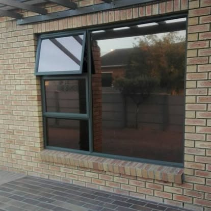 Aluminium-framed residential window with bronze tint installed by Khuseleka Glass