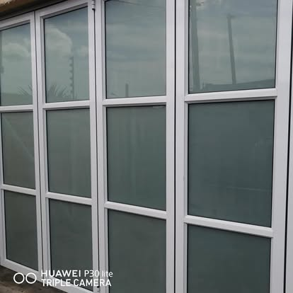 Aluminium-framed frosted sliding doors on a residential exterior